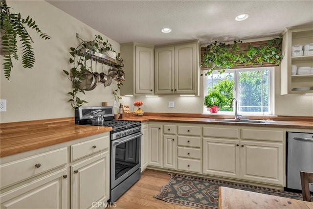 21425 Valley Oak Dr, Middletown, CA 95461 - kitchen featuring appliances with stainless steel finishes, butcher block countertops, a sink, light wood-style floors, and recessed lighting