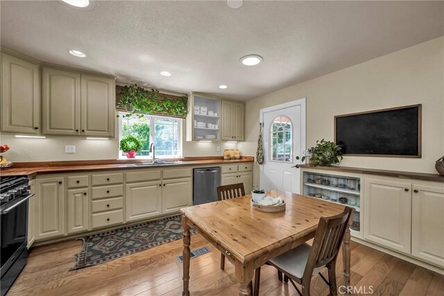 21425 Valley Oak Dr, Middletown, CA 95461 - kitchen featuring stainless steel dishwasher, a sink, black range with gas stovetop, healthy amount of natural light, and recessed lighting