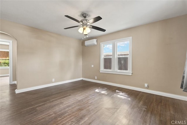 2981 Elgin St, Oroville, CA 95966 - empty room with a wall unit AC, baseboards, and dark wood-style floors