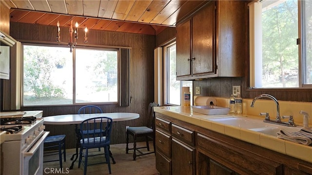 25 Manzanita, Running Springs, CA 92382 - kitchen featuring tile countertops, wood ceiling, white gas range, plenty of natural light, and wooden walls