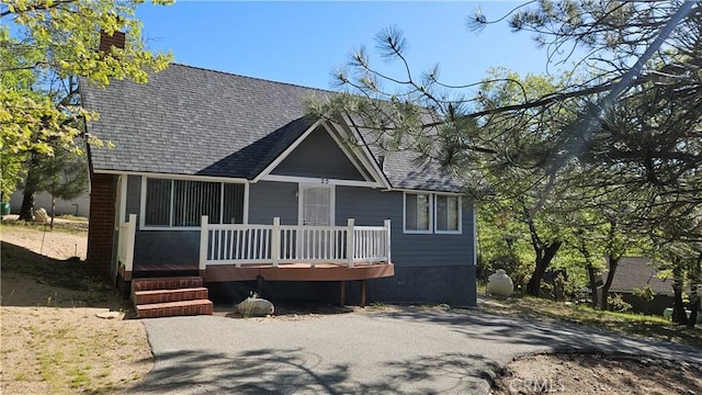 25 Manzanita, Running Springs, CA 92382 - view of front of property with roof with shingles, a chimney, and a wooden deck