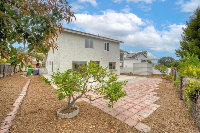 back of property with stucco siding, a patio, and a fenced backyard