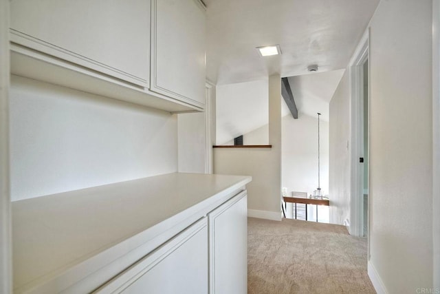 hall featuring light carpet and baseboards