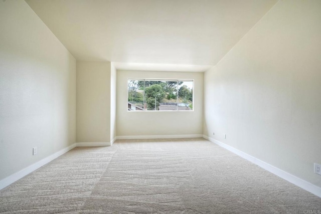 empty room with carpet flooring and baseboards