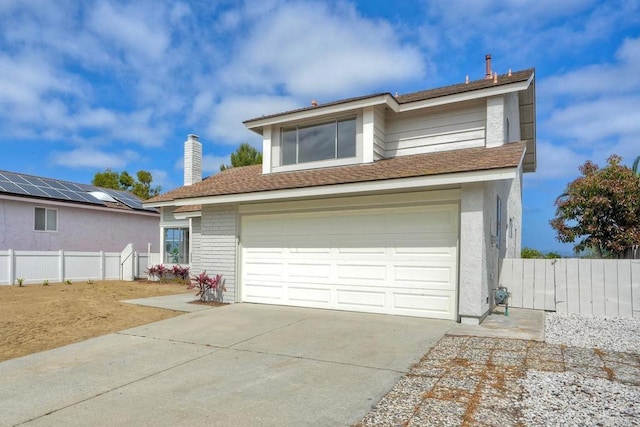 view of front facade featuring fence, concrete driveway, an attached garage, and brick siding