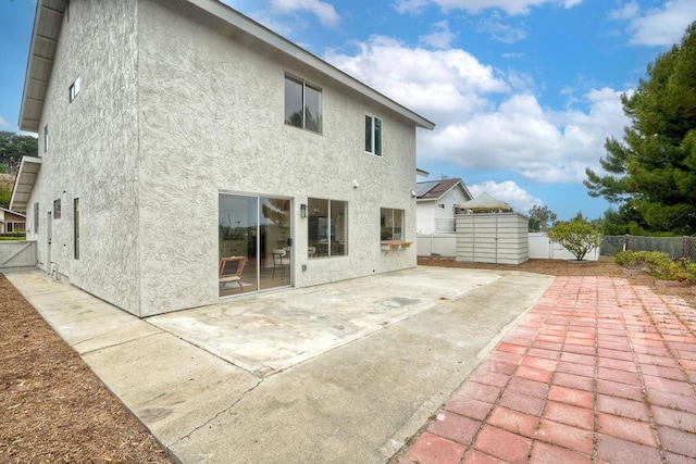 back of property featuring stucco siding, a fenced backyard, and a patio