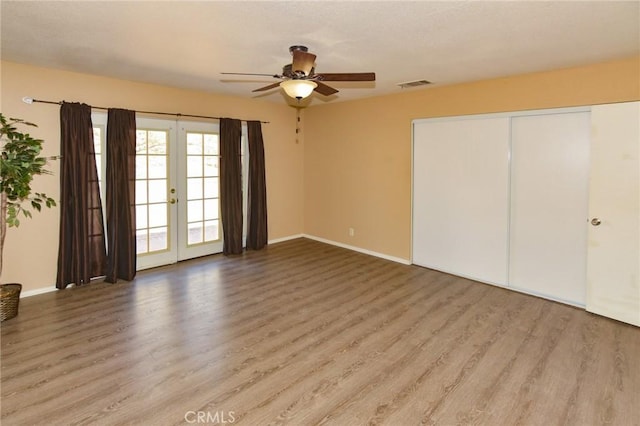 27314 Outrigger Ln, Helendale, CA 92342 - unfurnished bedroom with wood finished floors, baseboards, french doors, access to exterior, and ceiling fan