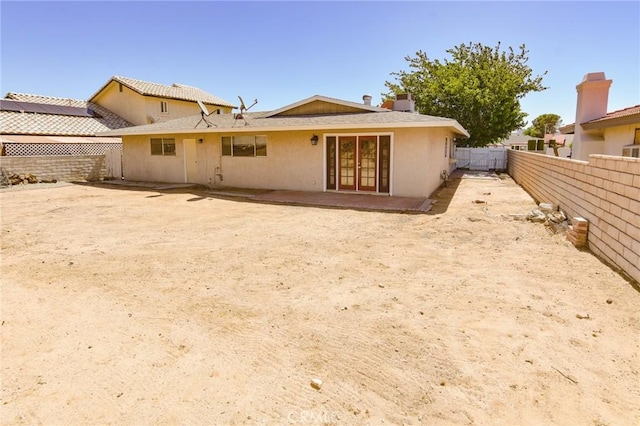 27314 Outrigger Ln, Helendale, CA 92342 - rear view of house with a fenced backyard, french doors, stucco siding, and a patio