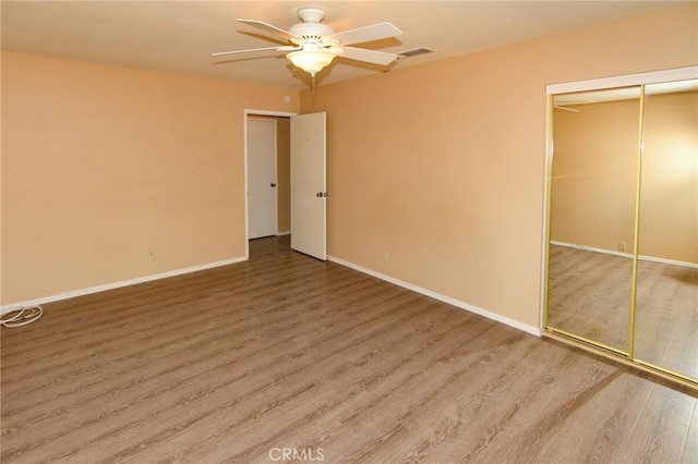 27314 Outrigger Ln, Helendale, CA 92342 - unfurnished bedroom with wood finished floors, baseboards, a closet, and ceiling fan