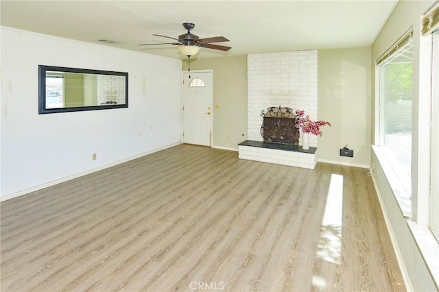 27314 Outrigger Ln, Helendale, CA 92342 - unfurnished living room with wood finished floors, a ceiling fan, baseboards, and a brick fireplace