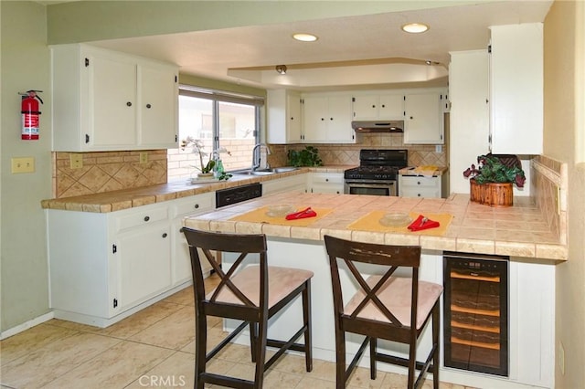 27314 Outrigger Ln, Helendale, CA 92342 - kitchen with gas range, beverage cooler, under cabinet range hood, a sink, and a peninsula