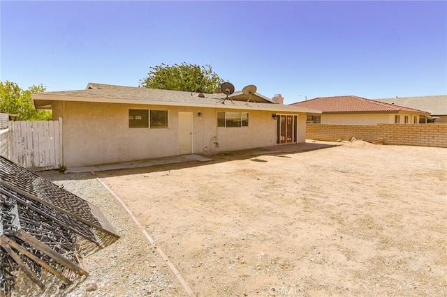 27314 Outrigger Ln, Helendale, CA 92342 - rear view of property featuring a fenced backyard, stucco siding, and a patio