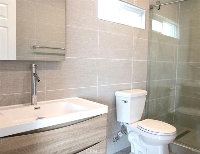 2437 Houston St, Los Angeles, CA 90033 - full bathroom with tile walls, toilet, vanity, a stall shower, and decorative backsplash