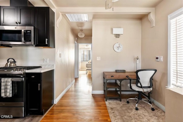 256 Melrose Dr, Oxnard, CA 93035 - kitchen featuring stainless steel appliances, dark cabinetry, plenty of natural light, and light wood finished floors