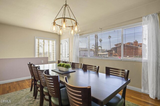 256 Melrose Dr, Oxnard, CA 93035 - dining space featuring a chandelier, wood finished floors, and baseboards