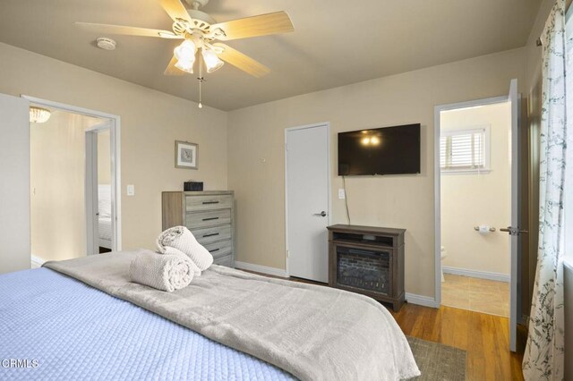256 Melrose Dr, Oxnard, CA 93035 - bedroom with wood finished floors, baseboards, ensuite bathroom, and a ceiling fan