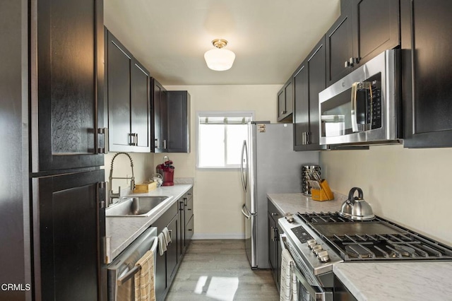 256 Melrose Dr, Oxnard, CA 93035 - kitchen featuring stainless steel appliances, a sink, light wood finished floors, and light countertops