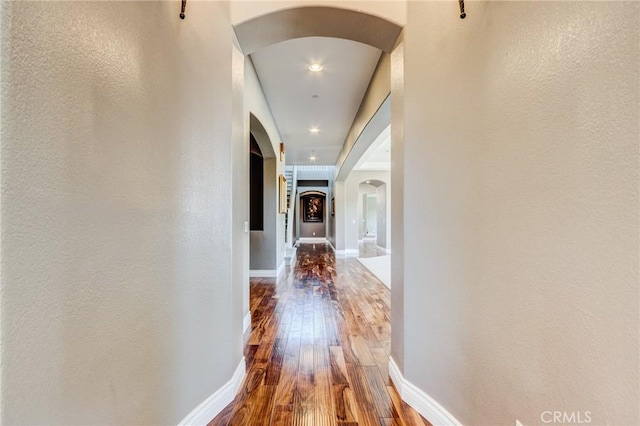 13195 Trailwood Way, Apple Valley, CA 92308 - corridor featuring arched walkways, hardwood / wood-style floors, baseboards, a textured wall, and recessed lighting