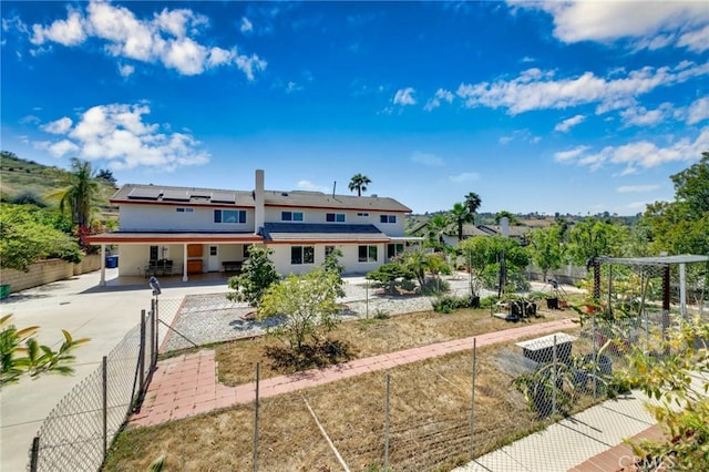 1158 Regal Canyon Dr, Walnut, CA 91789 - back of house with solar panels, concrete driveway, a fenced backyard, and stucco siding