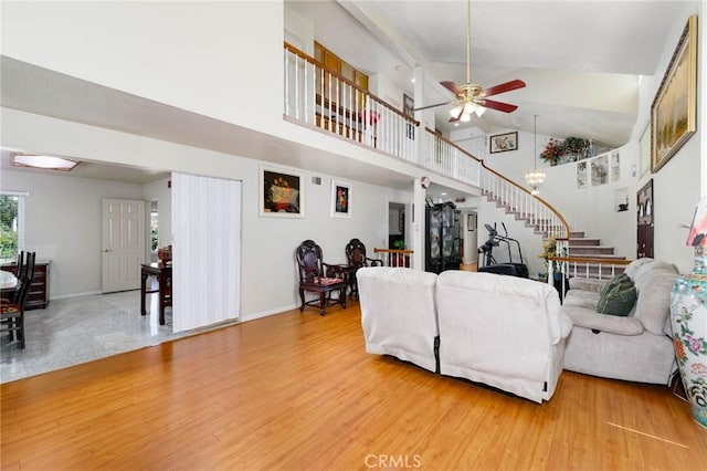 1158 Regal Canyon Dr, Walnut, CA 91789 - living area with stairway, high vaulted ceiling, a ceiling fan, light wood-style flooring, and baseboards
