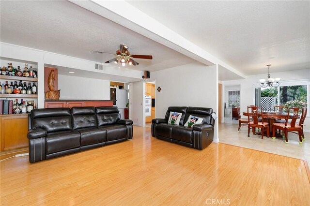 1158 Regal Canyon Dr, Walnut, CA 91789 - living area with a chandelier, light wood-type flooring, and a ceiling fan