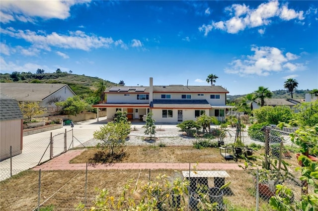 1158 Regal Canyon Dr, Walnut, CA 91789 - rear view of property with roof mounted solar panels, driveway, and an attached carport