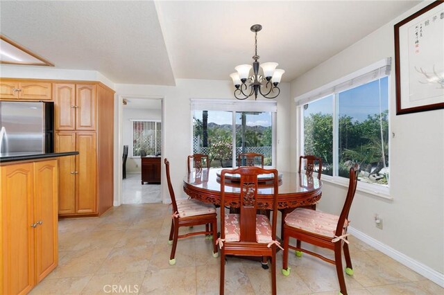 1158 Regal Canyon Dr, Walnut, CA 91789 - dining area featuring a chandelier, plenty of natural light, baseboards, and light tile patterned flooring