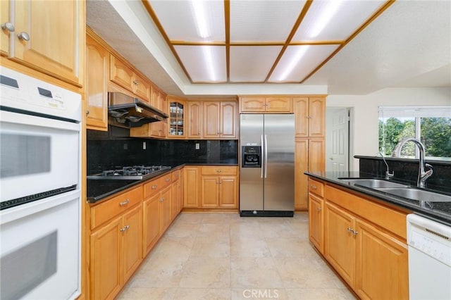 1158 Regal Canyon Dr, Walnut, CA 91789 - kitchen with appliances with stainless steel finishes, a sink, under cabinet range hood, tasteful backsplash, and glass insert cabinets