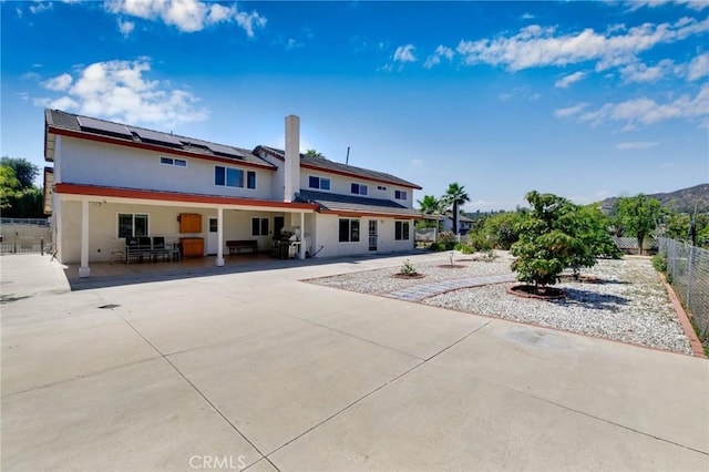 1158 Regal Canyon Dr, Walnut, CA 91789 - rear view of property featuring a patio, roof mounted solar panels, a fenced backyard, and stucco siding