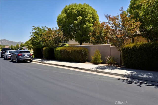 29424 Springside Dr, Menifee, CA 92584 - view of asphalt street featuring sidewalks, a mountain view, and curbs
