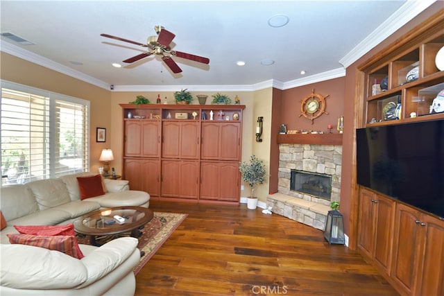 29424 Springside Dr, Menifee, CA 92584 - living room featuring a ceiling fan, dark wood-style flooring, a stone fireplace, ornamental molding, and recessed lighting