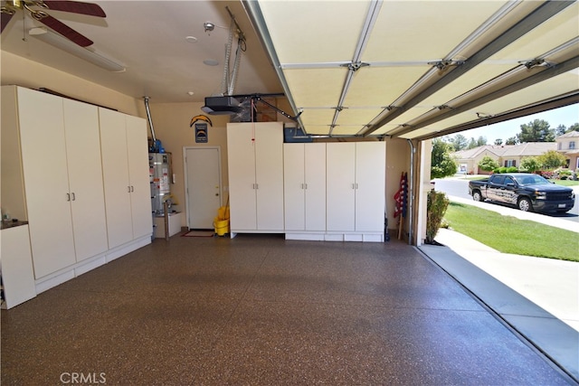 29424 Springside Dr, Menifee, CA 92584 - garage featuring a garage door opener, strapped water heater, and a ceiling fan