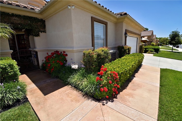 29424 Springside Dr, Menifee, CA 92584 - view of property exterior featuring a garage, a tile roof, central AC unit, and stucco siding