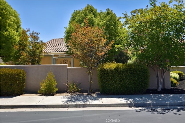 29424 Springside Dr, Menifee, CA 92584 - view of home's exterior featuring a fenced front yard, stucco siding, and a tile roof