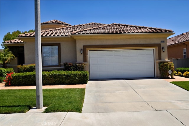 29424 Springside Dr, Menifee, CA 92584 - mediterranean / spanish-style house featuring concrete driveway, stucco siding, an attached garage, a tile roof, and a front lawn