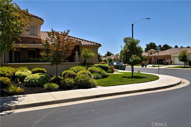 29424 Springside Dr, Menifee, CA 92584 - view of asphalt road featuring sidewalks, street lights, curbs, and a residential view