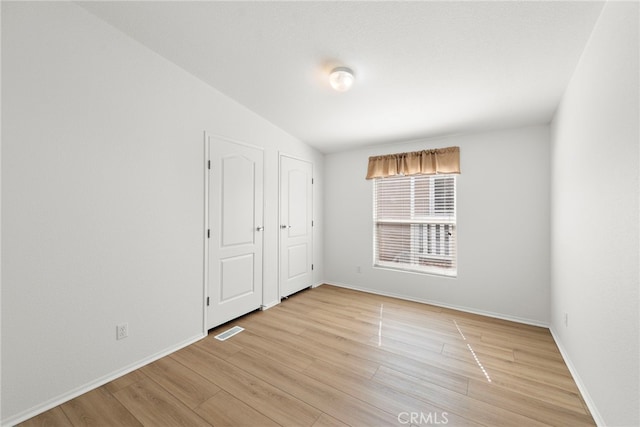 2851 Rolling Hills Dr Unit 224, Fullerton, CA 92835 - unfurnished bedroom with light wood-style flooring and lofted ceiling