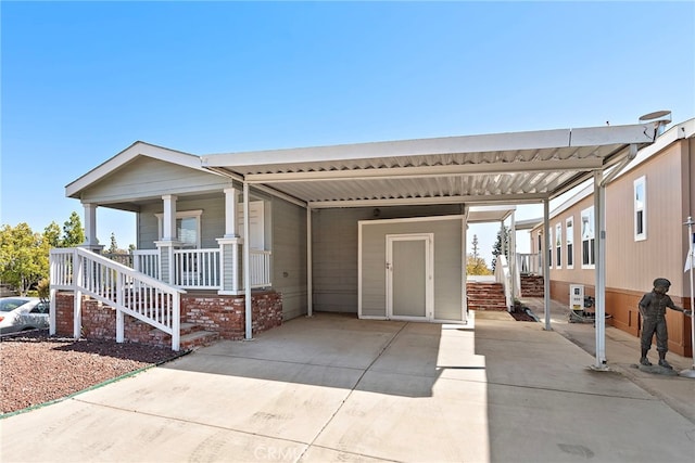 2851 Rolling Hills Dr Unit 224, Fullerton, CA 92835 - view of front of house featuring an attached carport, driveway, and covered porch