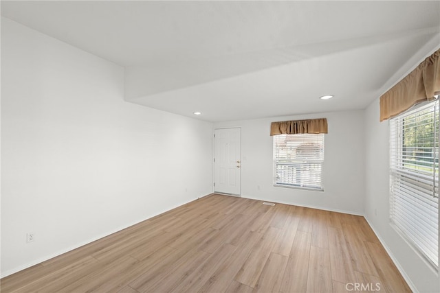unfurnished room with light wood-style flooring, baseboards, and recessed lighting