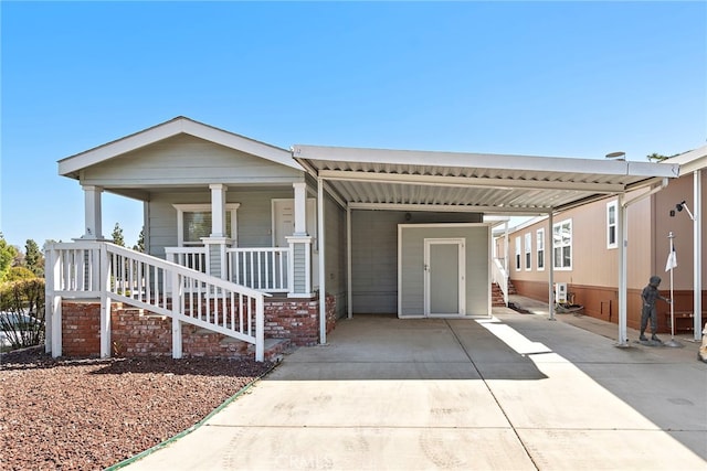 2851 Rolling Hills Dr Unit 224, Fullerton, CA 92835 - view of front of home with concrete driveway, a carport, and covered porch