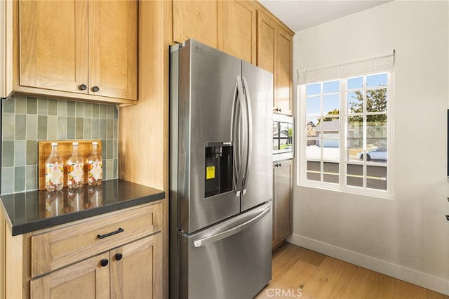 20010 Ingrum Way, Torrance, CA 90503 - kitchen featuring stainless steel fridge, baseboards, light wood-style flooring, dark countertops, and backsplash