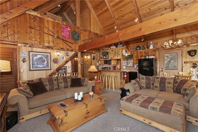 43214 Sunset Dr, Big Bear Lake, CA 92315 - carpeted living room featuring wooden walls, high vaulted ceiling, a chandelier, and wooden ceiling with exposed beams