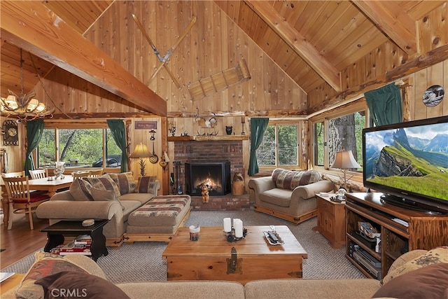 43214 Sunset Dr, Big Bear Lake, CA 92315 - living room with high vaulted ceiling, wood walls, plenty of natural light, wood ceiling with exposed beams, and a chandelier