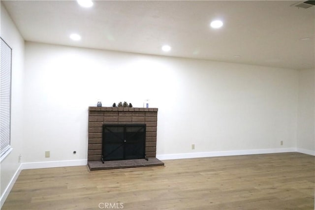 11010 Davis St, Moreno Valley, CA 92557 - unfurnished living room with wood finished floors, a fireplace, recessed lighting, and baseboards