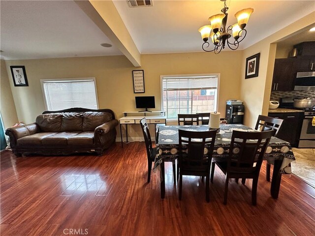 6127 Adenmoor Ave, Lakewood, CA 90713 - dining room featuring wood finished floors and a chandelier