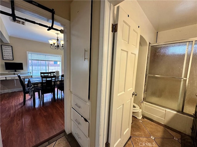 6127 Adenmoor Ave, Lakewood, CA 90713 - full bathroom with toilet, a chandelier, combined bath / shower with glass door, and tile patterned floors