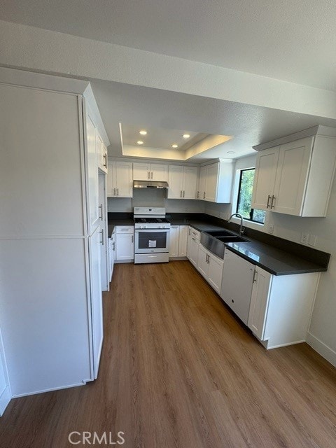 171 Junipero Serra Dr Unit D, San Gabriel, CA 91776 - kitchen featuring white gas range, a sink, dark wood-style floors, dark countertops, and recessed lighting