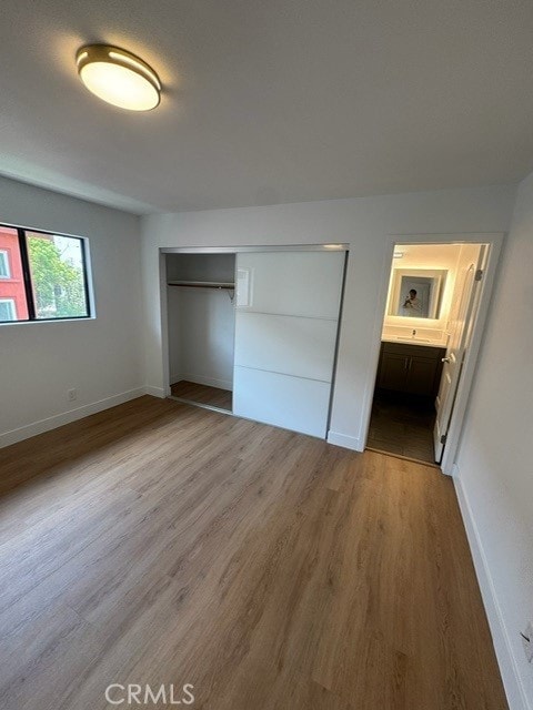 171 Junipero Serra Dr Unit D, San Gabriel, CA 91776 - unfurnished bedroom featuring wood finished floors, baseboards, a closet, and ensuite bathroom