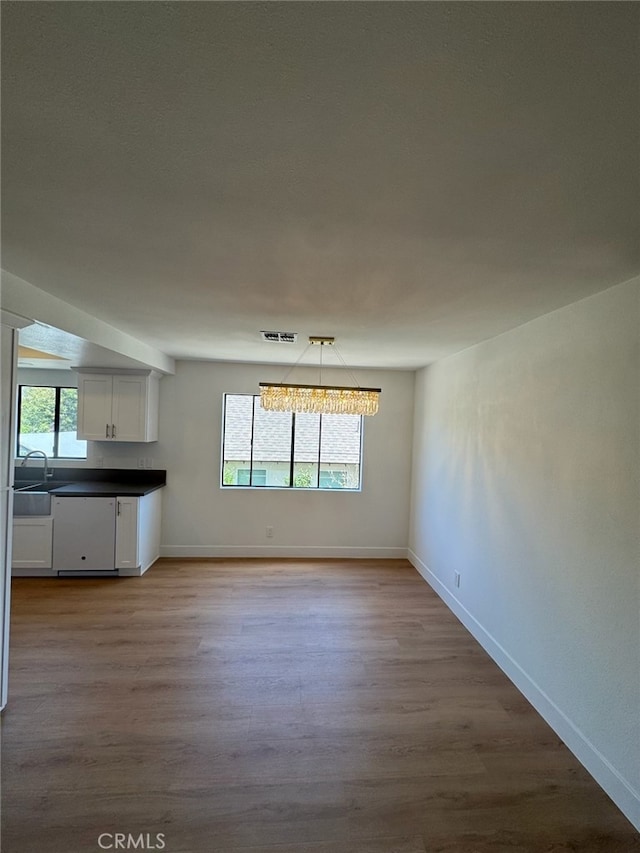 171 Junipero Serra Dr Unit D, San Gabriel, CA 91776 - unfurnished dining area featuring healthy amount of natural light, wood finished floors, baseboards, and a sink