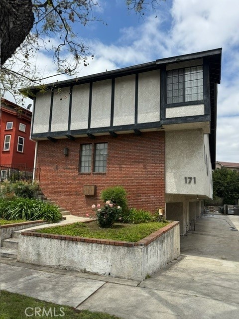 171 Junipero Serra Dr Unit D, San Gabriel, CA 91776 - view of property exterior with brick siding, stucco siding, concrete driveway, and a garage